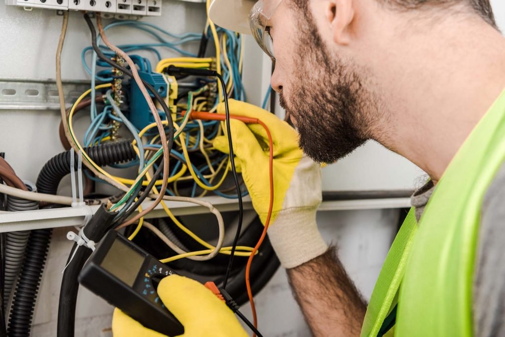 side-view-of-electrician-checking-electrical-box-w-LBPF6XT.jpg